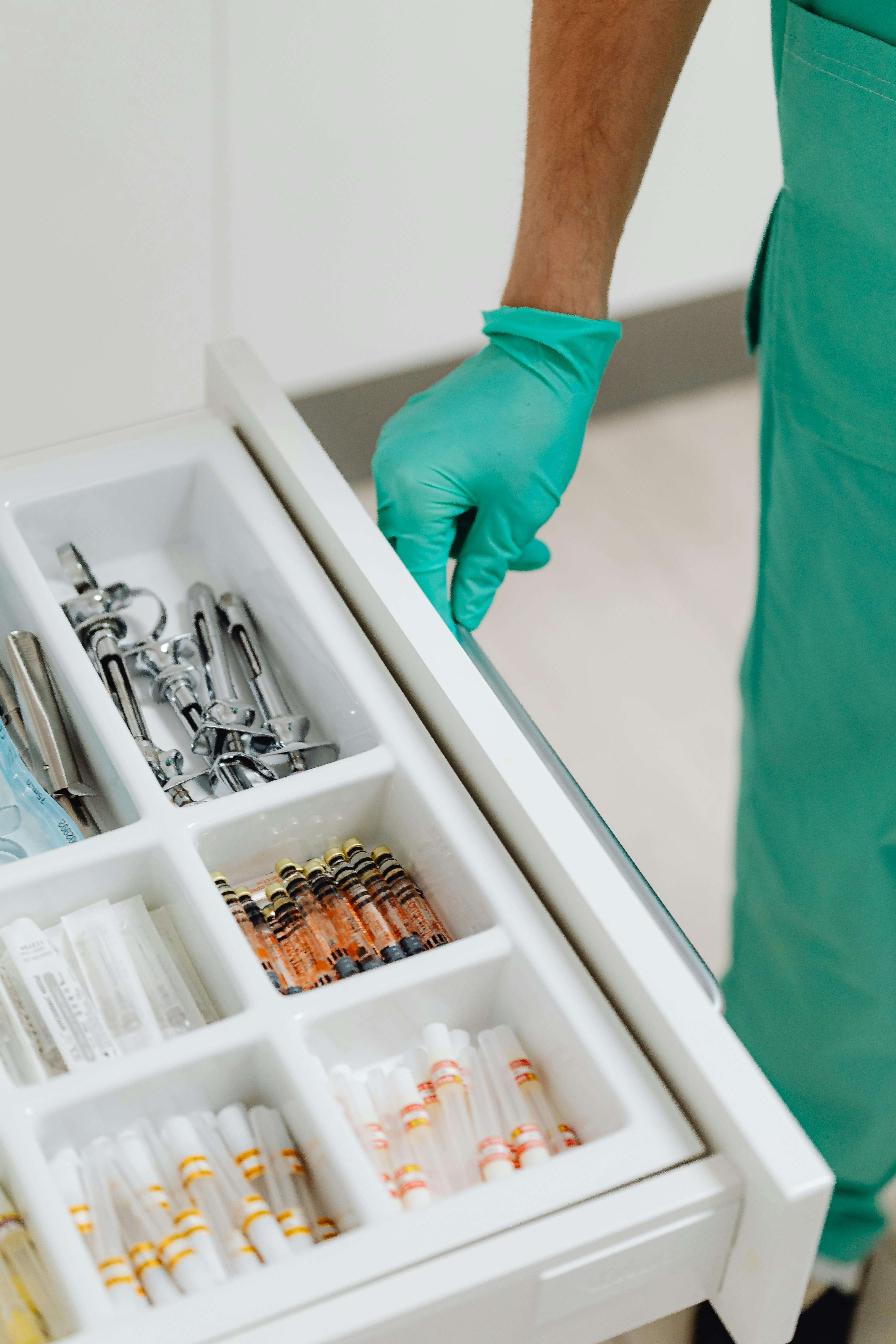 Clinician accessing sterile instruments and supplies from an organized drawer